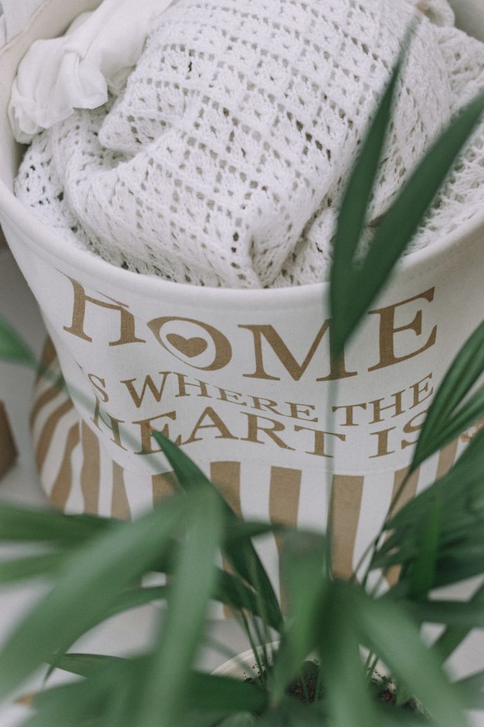 services-03 Soft textiles in a stylish bag with a plant, perfect for home decor inspiration.