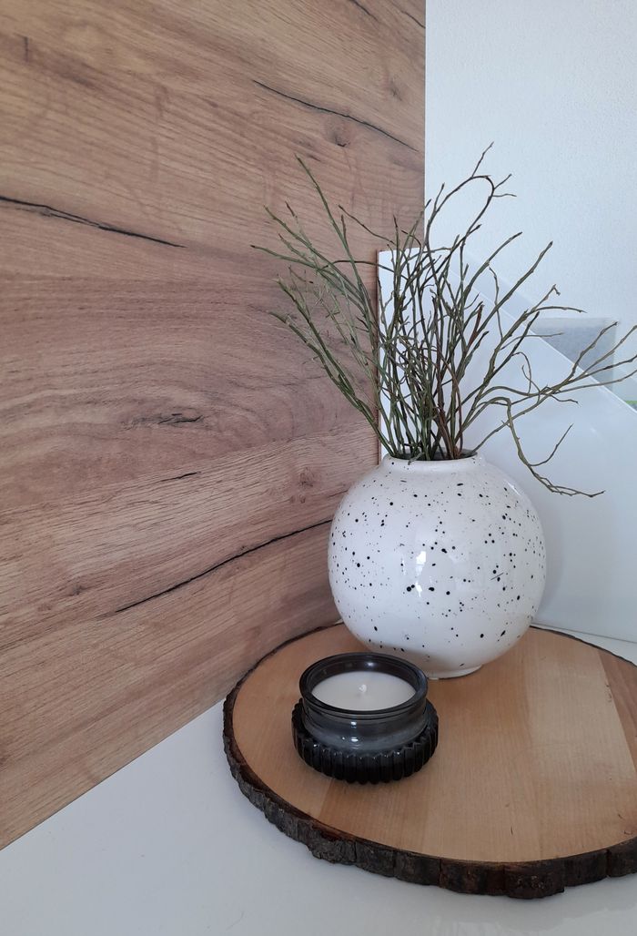services-02 Chic interior scene featuring a ceramic vase with decorative branches on a wooden tray.